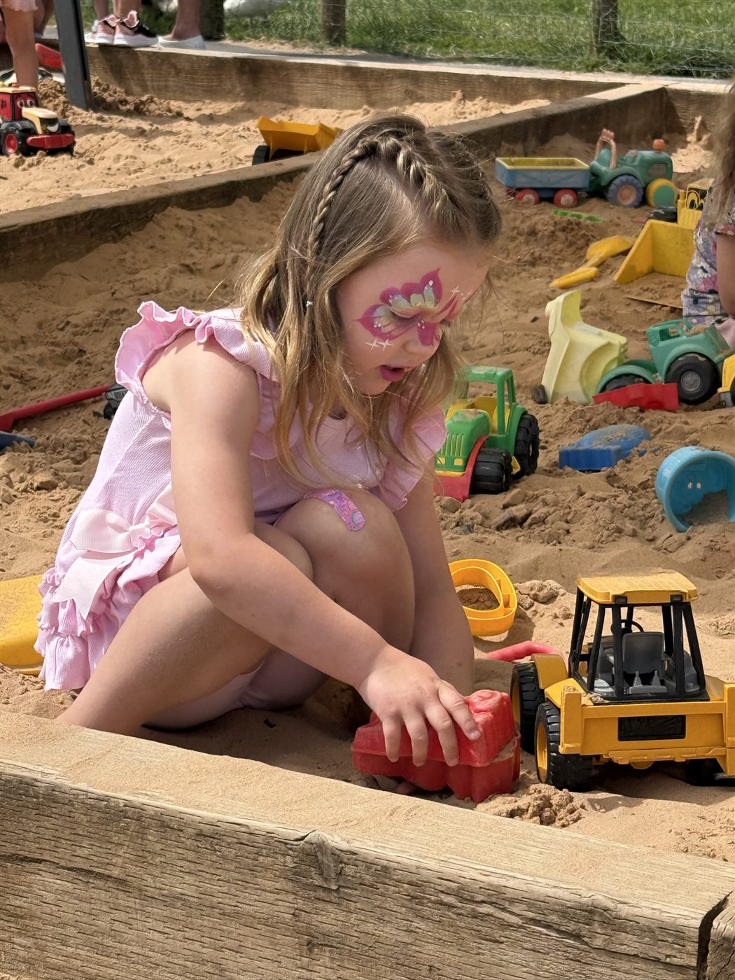 A child at a farm on a bright day