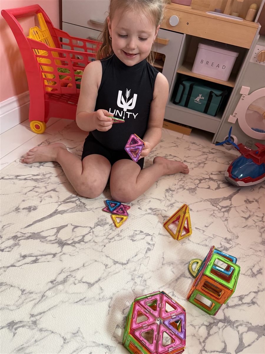 A child building with magnetic tiles